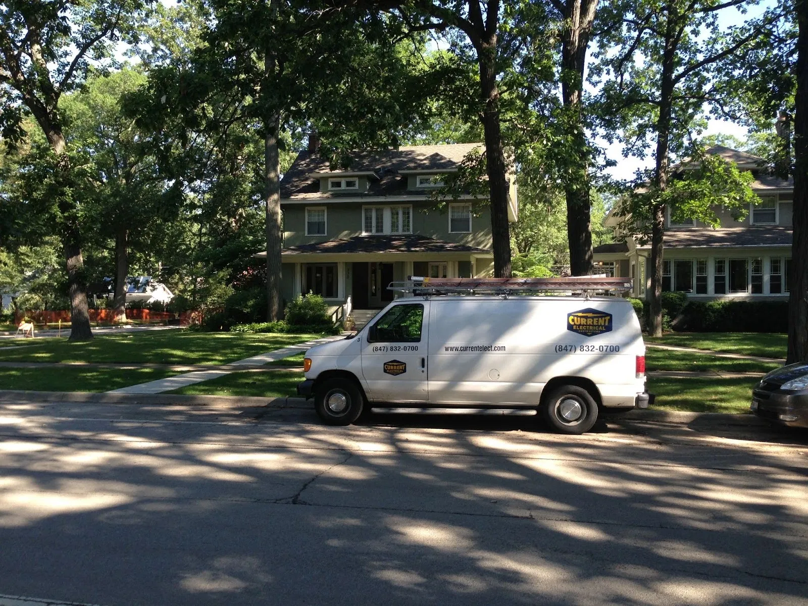 Current Electrical Contractors van parked outside a home for a generator installation call