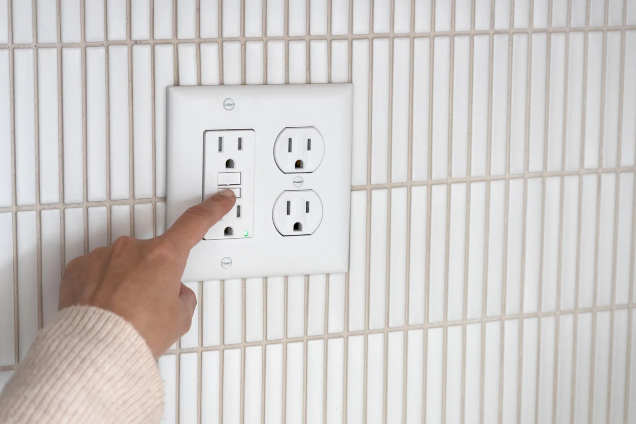 Homeowner troubleshooting a GFCI outlet